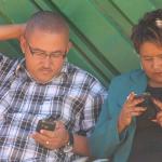 people looking at their phones mobile data Zimbabwe