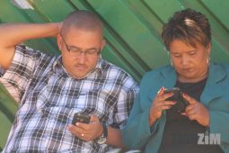 people looking at their phones mobile data Zimbabwe