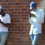 Two men holding phones, on social media