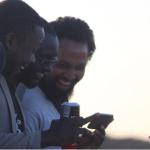 Men staring at a phone, Zero-rate, techzim