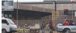 People outside the Zimbabwe Tobacco processors building