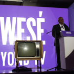 An old TV set in front of a Kwese logo